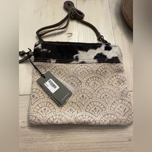 Myra crossbody bag with cowhid accent.